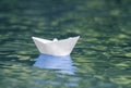 Close-up of simple small white origami paper boat floating quiet Royalty Free Stock Photo