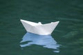 Close-up of simple small white origami paper boat floating quiet Royalty Free Stock Photo