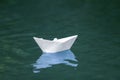 Close-up of simple small white origami paper boat floating quiet Royalty Free Stock Photo