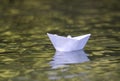 Close-up of simple small white origami paper boat floating quiet Royalty Free Stock Photo