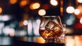 Close up a single glass drink on the rock, whiskey shot with big ice cube, clear brown color alcohol whisky drink, bokeh blurred Royalty Free Stock Photo