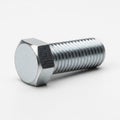 Close-up of a Single Hexagonal Bolt with Threaded Shaft on White Background Royalty Free Stock Photo