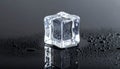 Ice Cube on Dark Surface with Water Droplets Royalty Free Stock Photo