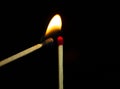 Close up Single matchstick burning isolated on black background Royalty Free Stock Photo