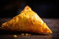 close-up of a single samosa with visible layers of crispy pastry