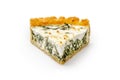 Close up of a single slice of Spinach and feta cheese pie isolated on white. View from above