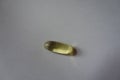 Closeup of single softgel capsule of fish oil