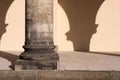 Close-up of single stone corinthian column and portico with blank wall