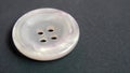 close up of single transparent white plastic button