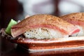 Close-up of a single tuna nigiri sushi showing the side view of Tuna fish and rice in a plate. the Tuna nigiri is in focus Royalty Free Stock Photo