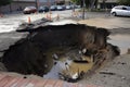 close-up of sinkhole, with water and debris visible