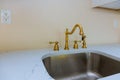 Close up of sinks in modern white kitchen with white stone