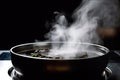 close-up of sizzling pan, with smoke and steam rising