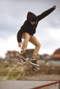 Close up of a skateboarders feet while skating active performance of stunt teenager shot in the air on a skateboard in a