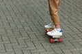 Close up of a skateboarders feet while skating on concrete at the skate park