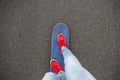 Skateboarders feet while skating through the street