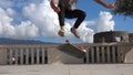 Close up of skater skateboarder man doing 360 kickflip heelflip flip trick in slow motion jump