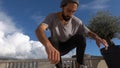 Close up of skater skateboarder man doing 360 kickflip heelflip flip trick in slow motion jump