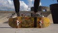 Close up of skater skateboarder man doing 360 kickflip heelflip flip trick in slow motion jump