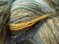 Close-up Of Skein Of Multi-textured Yarn In Color Sequence, Blues, Aquas, Golds