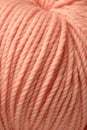 A close up of a skein yarn that is peach fuzz color, AI