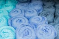 Close-up of skeins of thread in turquoise, blue and grey pastel colors. Thread background