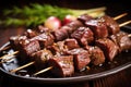 close-up of a skewer with perfectly browned slices of beef