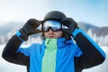 Close up of the ski goggles of a man with the reflection of snowed mountains. A mountain range reflected in the ski mask Royalty Free Stock Photo