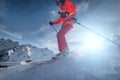 Close up Skier rides on a snowy slope on a sunny day at sunset against the backdrop of the mountains. The concept of