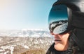 Close up skiers female person goggles with mountains panorama reflection. Ski holiday in caucasus mountains