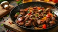 Close up of a skillet with seasoned meat, veggies, and spices Royalty Free Stock Photo