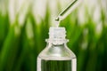 Close up skin care that is useful for moisturizing and brightening facial skin on blur green grass background, soft