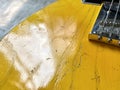 Close-up of the skin of an electric guitar. Which has yellow texture and has a dimensional wood texture with copy space. Royalty Free Stock Photo