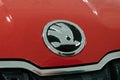 Close up Skoda logo on red new car at motor show