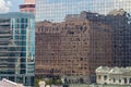 Close up of skyscraper with buildings reflecting in the windows