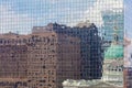 Close up of skyscraper with buildings reflecting in the windows