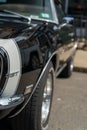 Close-up of a sleek black Chevrolet Camaro vehicle shining in the sunlight in Manchester