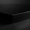 A close-up of a sleek, black rectangular block made of a glossy material, possibly Royalty Free Stock Photo