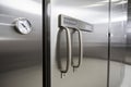 close-up of a sleek and modern walk-in freezer, with metal handles and digital temperature controls Royalty Free Stock Photo