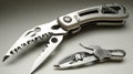 Close up of sleek silver multi tool pliers and smaller scissors against a neutral background Royalty Free Stock Photo