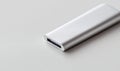 Close-up of a sleek silver USB drive on a bright surface, perfect for tech and data themes. Royalty Free Stock Photo