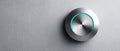 Modern metallic volume control knob with blue LED indicator on textured gray wall background in close-up Royalty Free Stock Photo