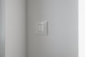 Close-up of a sleek white double rocker light switch mounted on a smooth light-gray wall Royalty Free Stock Photo