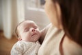 Close Up Of Sleeping Newborn Baby Being Held By Mother Royalty Free Stock Photo