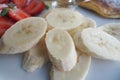 close up of slice of banana glass , strawberry and honey on a plate