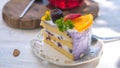 Close up Slice birthday fruit cake in plate violet delicious cream in layer