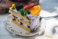 Close up Slice birthday fruit cake in plate violet delicious cream in layer Royalty Free Stock Photo