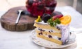 Close up Slice birthday fruit cake in plate violet delicious cream in layer Royalty Free Stock Photo