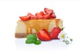 Close-up slice of delicious homemade cheesecake with fresh strawberries, spring flowers and caramel sauce Royalty Free Stock Photo