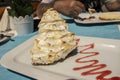 A close up of a slice of delicious lemon meringue pie served on a white plate Royalty Free Stock Photo